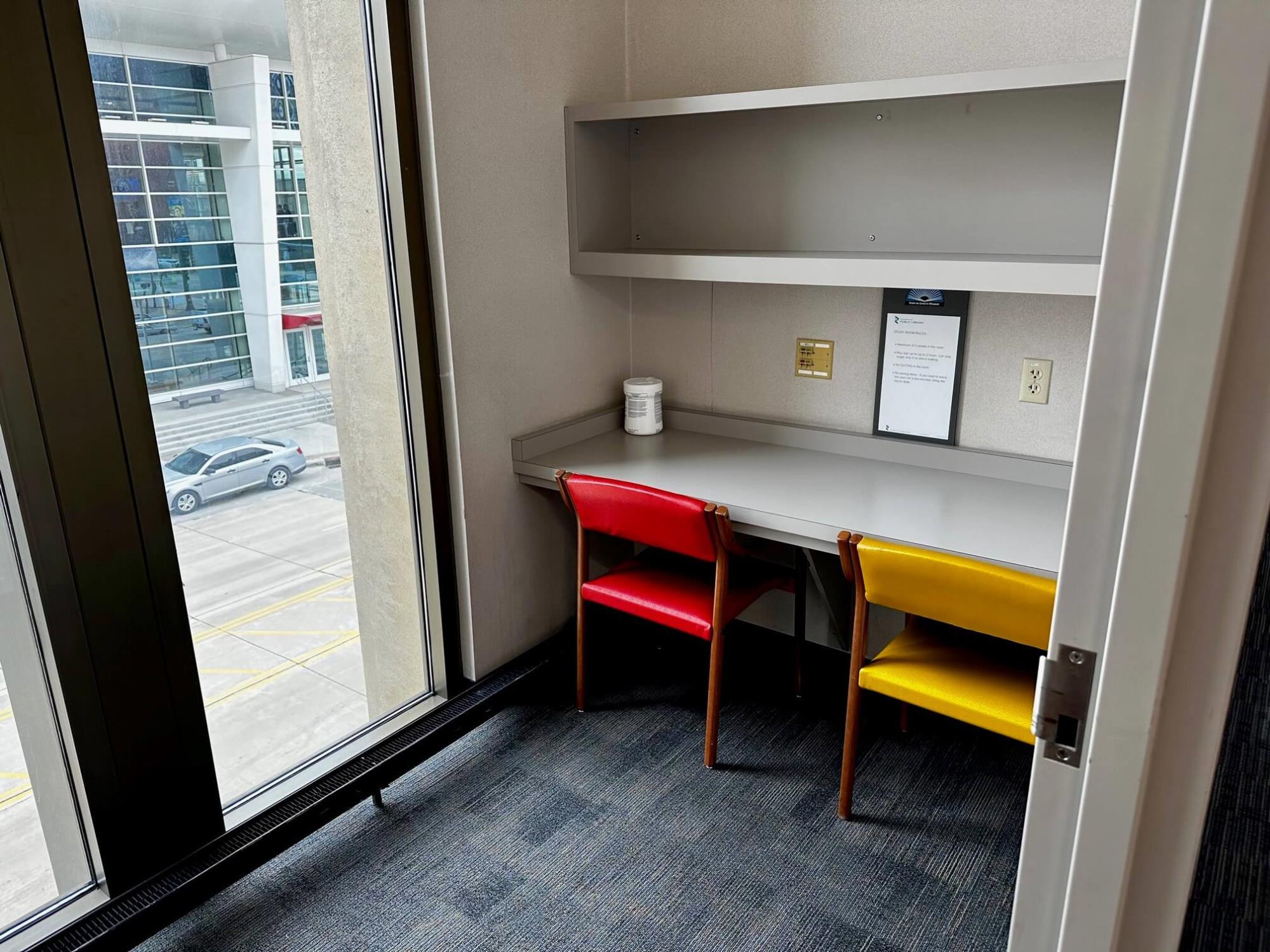 small room with one table and two chairs and a window