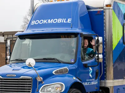 RPL Bookmobile focused on the cab with the driving waving
